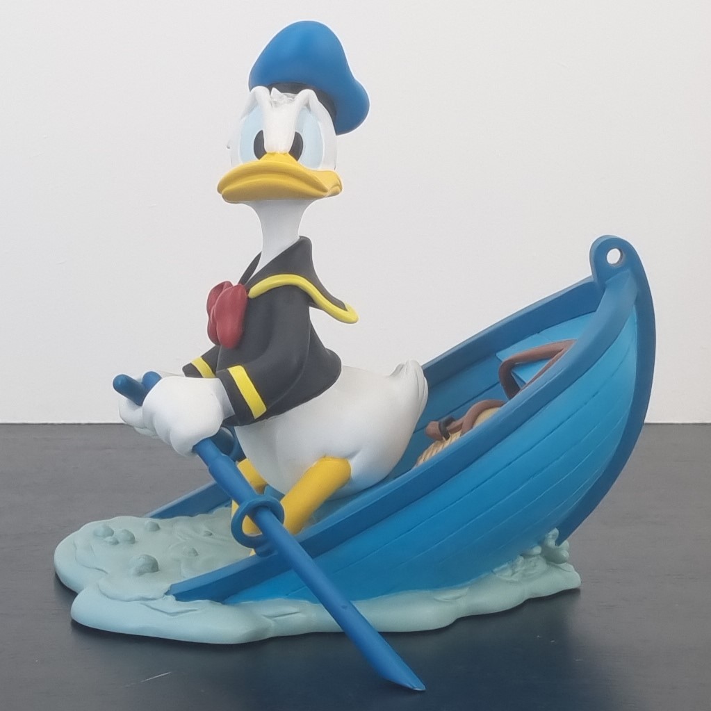 Donald Duck in a sinking boat figurine _left