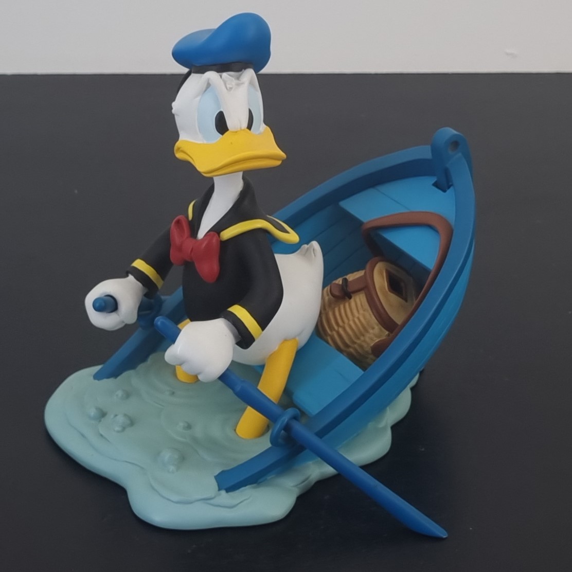 Donald Duck in a sinking boat figurine