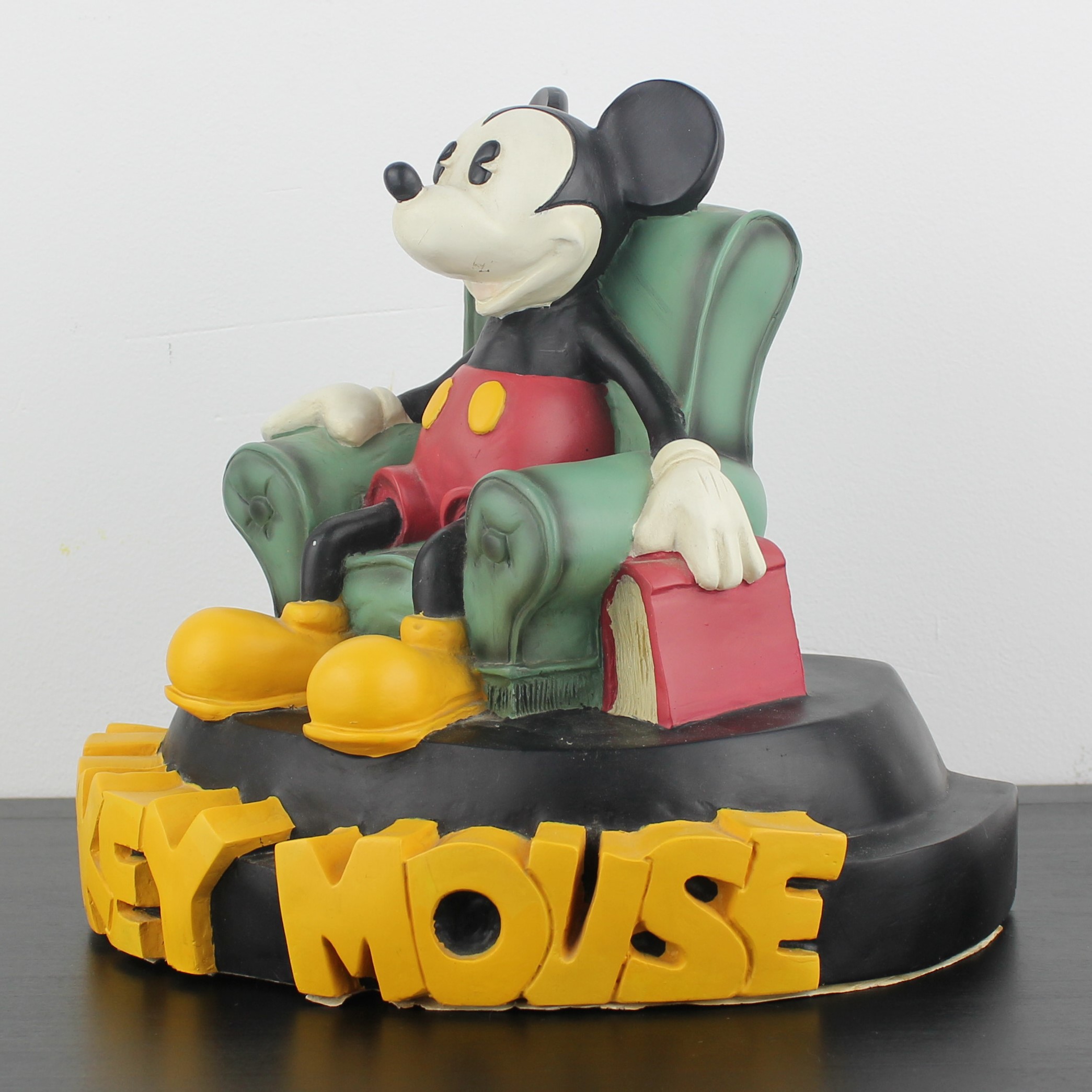 Mickey Mouse sitting in a green reading chair figurine _left front