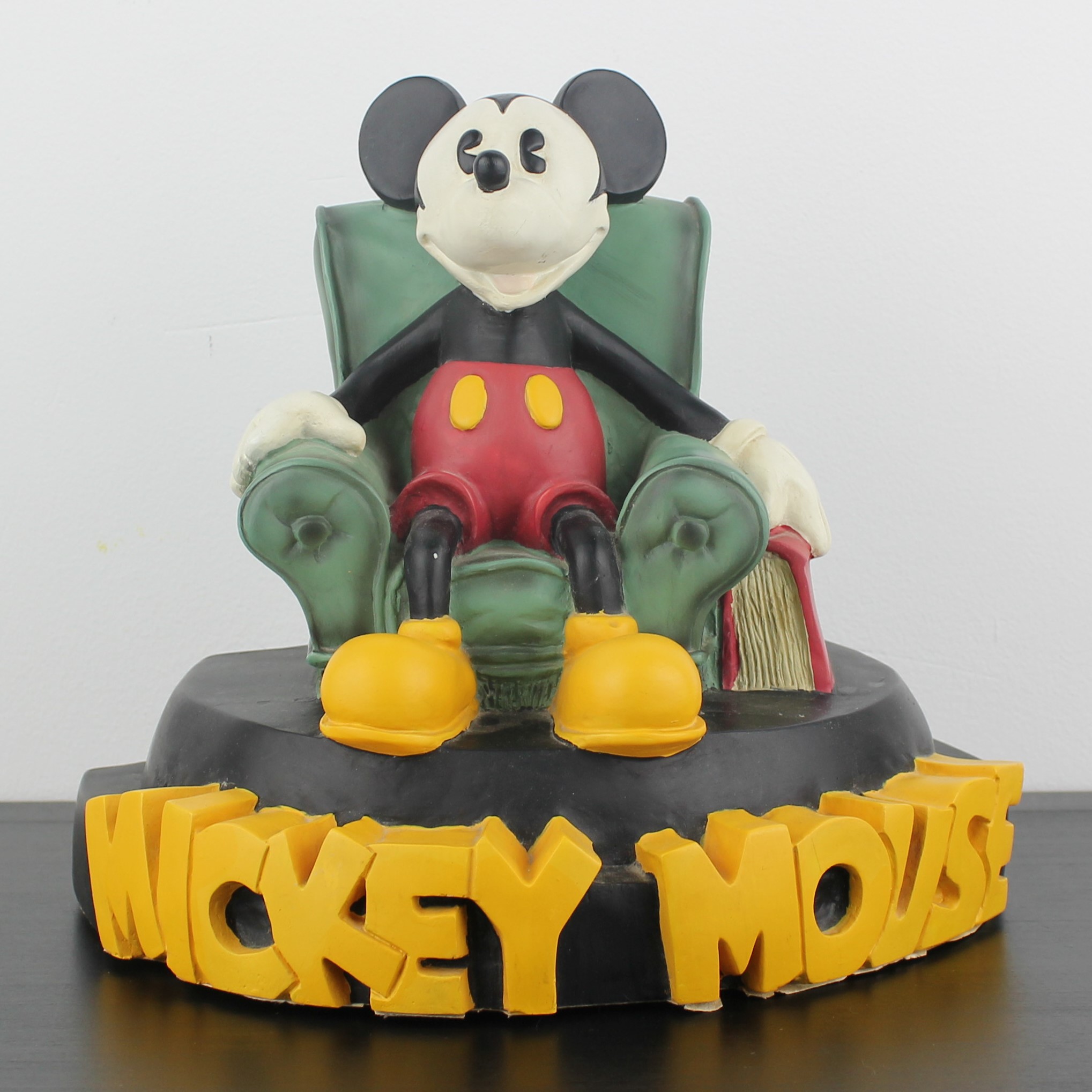 Mickey Mouse sitting in a green chair figurine