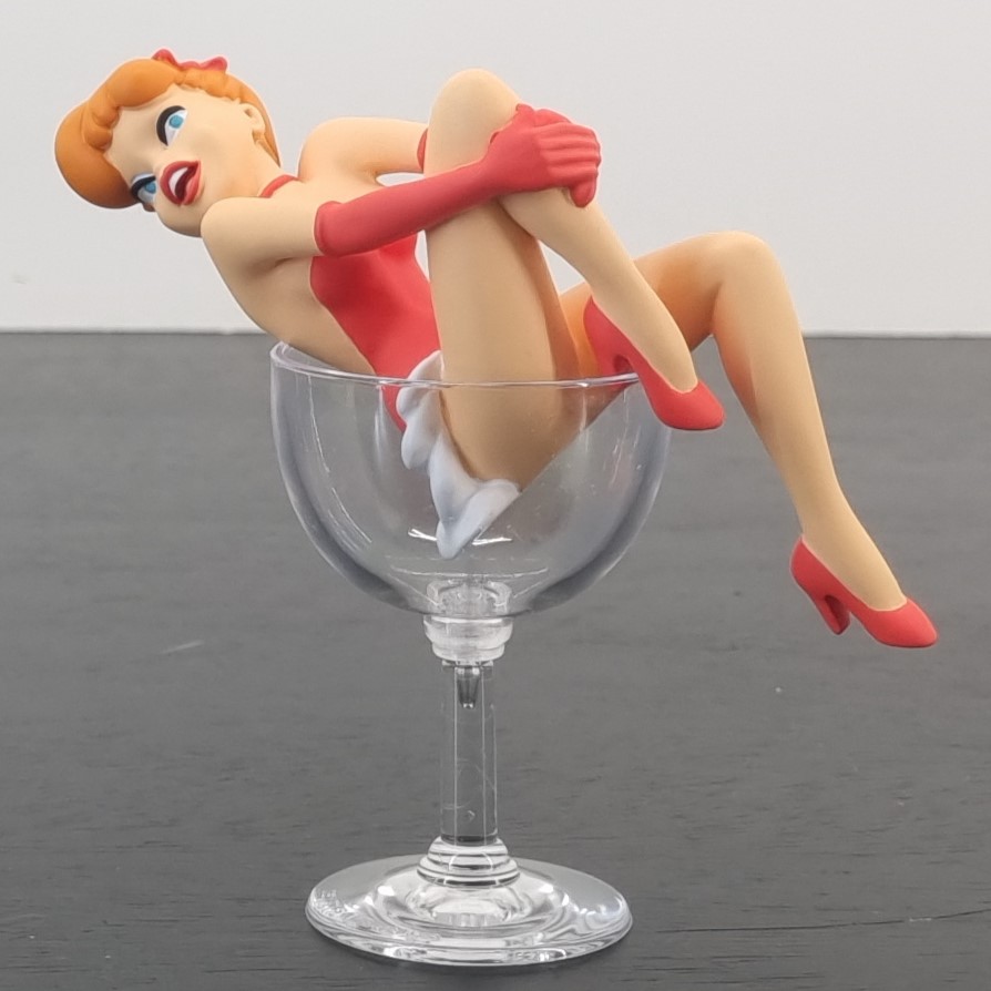 Red sitting in a glass figurine _left front