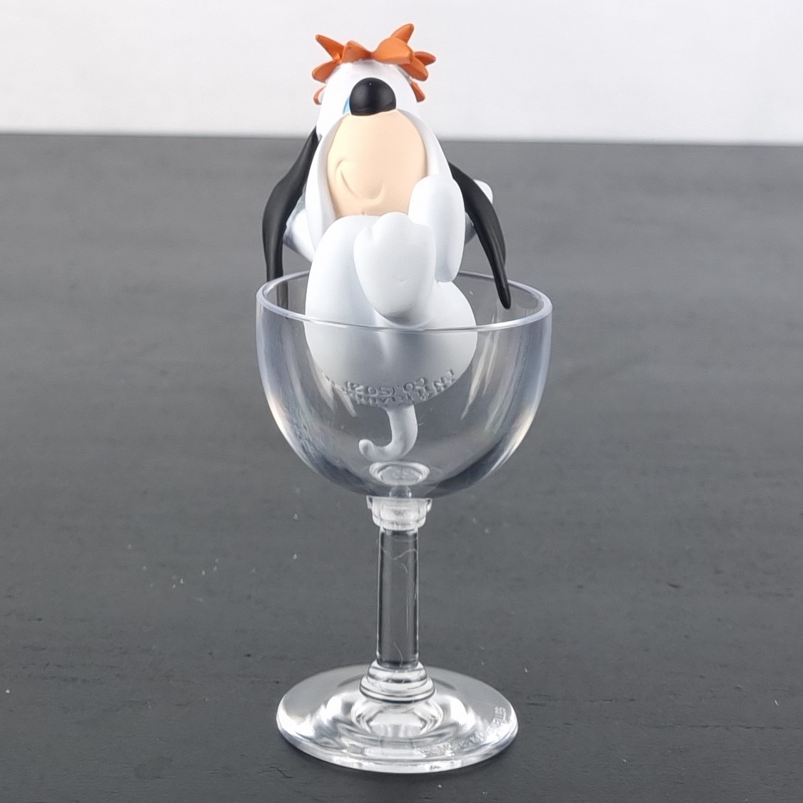 droopy sitting in a glass figurine _front