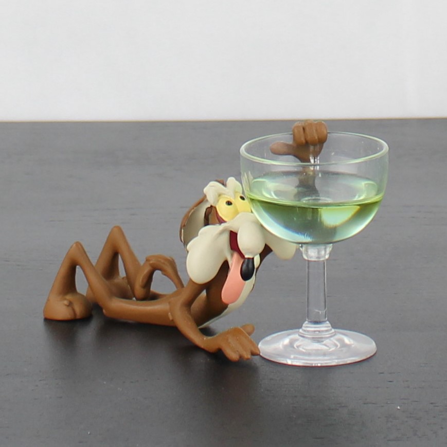 Wile E Coyote hanging at a glass figurine