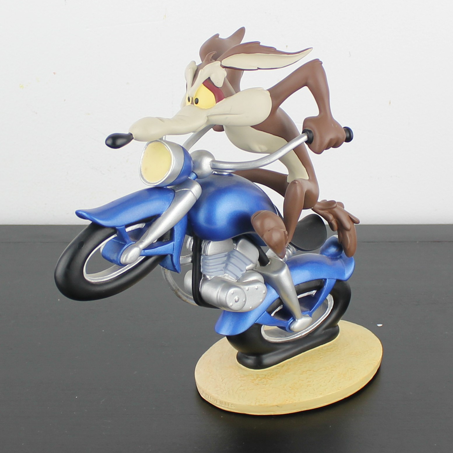 Wile E Coyote riding a motorcycle statue