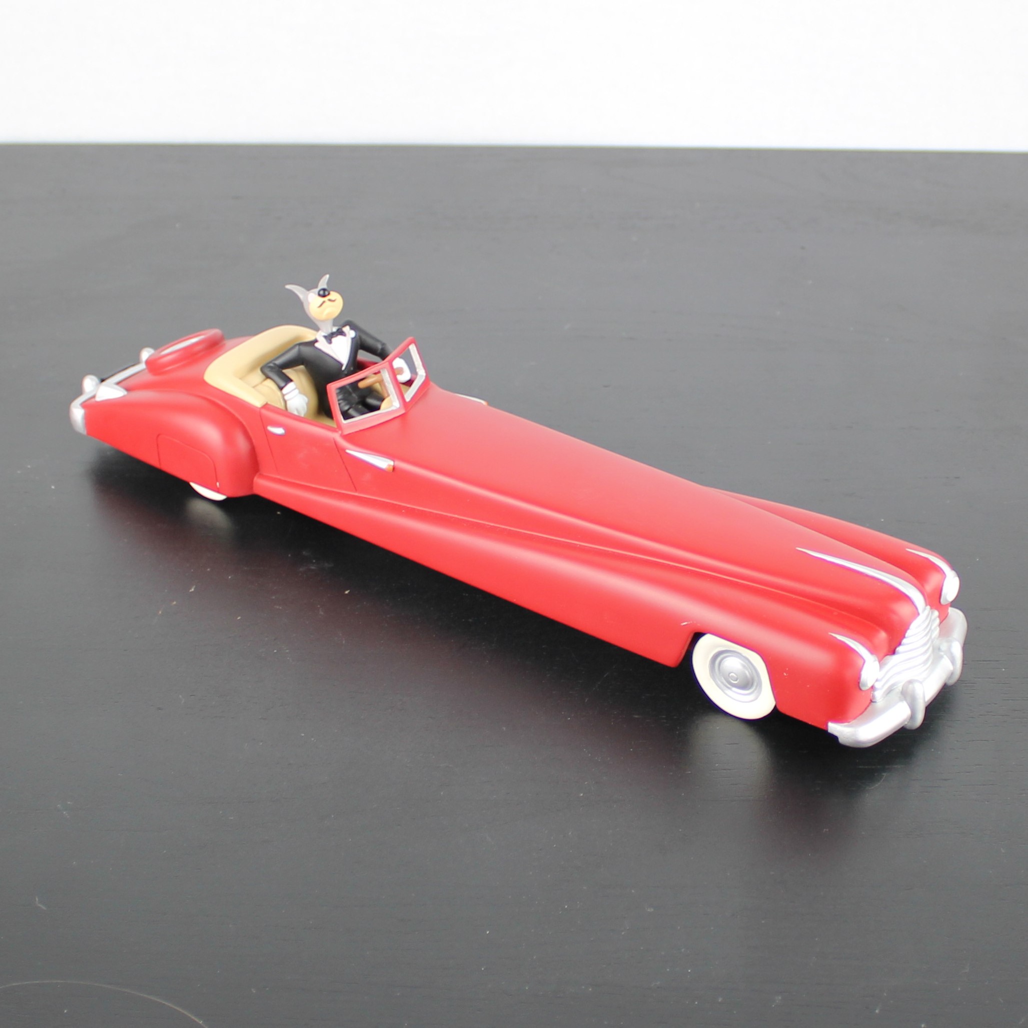 Wolf driving a red limousine statue